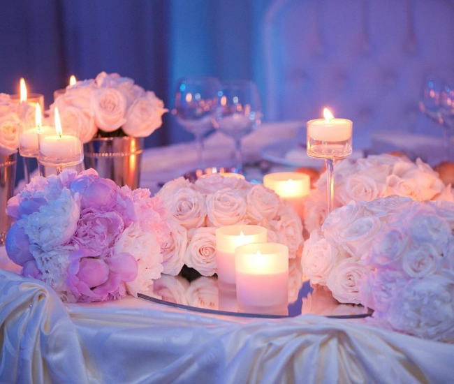 flowers and candles on a white table