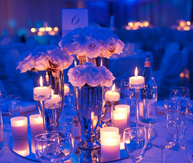 flowers and candles in a blue setting